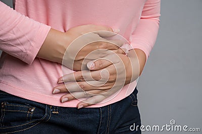 Young woman having painful stomachache. Chronic gastritis. Abdomen bloating and healthcare concept Stock Photo