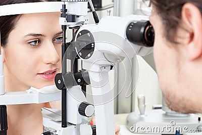 Young woman having an slit-lamp eye test in ophthalmology clinic Stock Photo