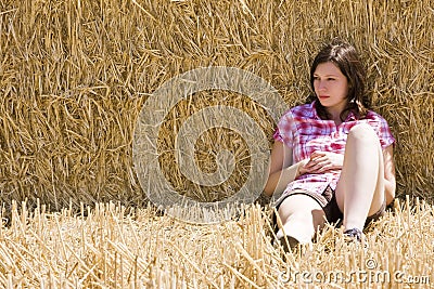 Young woman in haystack Stock Photo