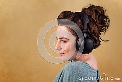 Young woman with headphones listening to music with copy space Stock Photo