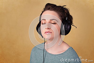 Young woman with headphones listening to music with copy space Stock Photo