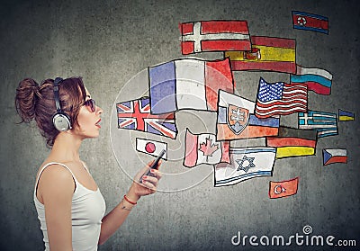 Young woman in headphones learning different languages Stock Photo