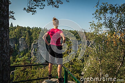 Young woman and her dog enjoy mountain hikes in summer Stock Photo