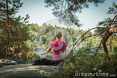 Young woman and her dog enjoy mountain hikes in summer Stock Photo