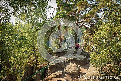 Young woman and her dog enjoy mountain hikes in summer Stock Photo