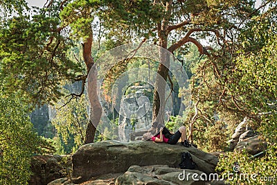 Young woman and her dog enjoy mountain hikes in summer Stock Photo