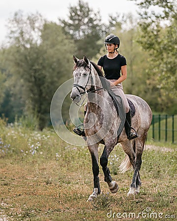 Young woman and her red horse during a calm trail ride Stock Photo