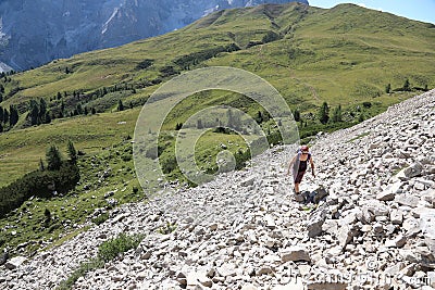 young woman hiker walking along a rough and very steep path alon Editorial Stock Photo