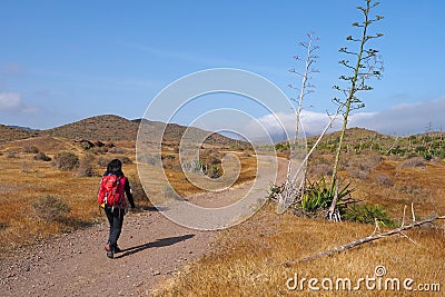 Young woman hiking in dry, desert-like Cabo di Gata Nature Park. Stock Photo