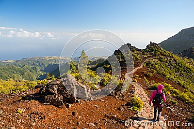 Young woman hiking on path to Pico Ruivo, highest peak of Madeira island, Portugal Stock Photo