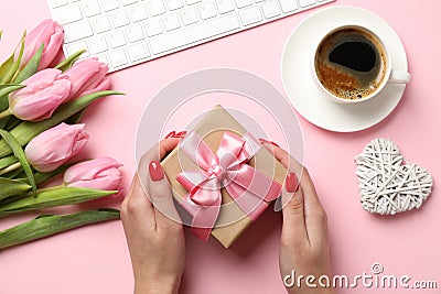 Young woman hold gift on decorated background, top view Editorial Stock Photo