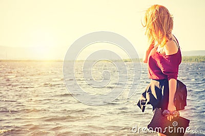 Young Woman holding bag walking outdoor Lifestyle Fashion Travel Stock Photo