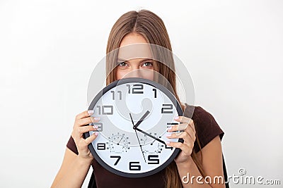 Young woman holding big wall clocks on white background. Stock Photo