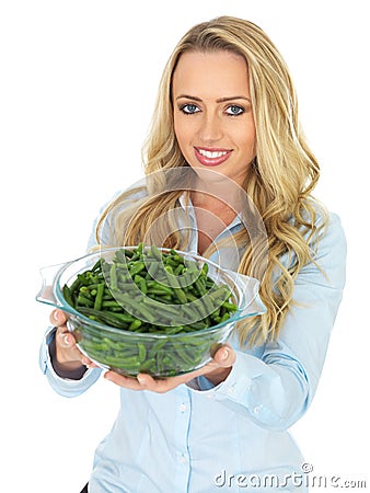 Young Woman Holding a Bowl of Cooked Green French Beans Stock Photo