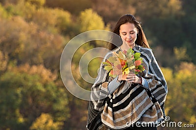 Young woman holding bunch of autumn leaves. Natural beauty. Fear of aging concept Stock Photo