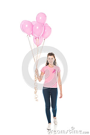 young woman holding bunch of pink balloons and smiling at camera Stock Photo