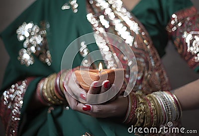 Young woman holding diwali lamp Stock Photo