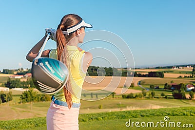 Young woman holding a driver club during golf swing at the begin Stock Photo