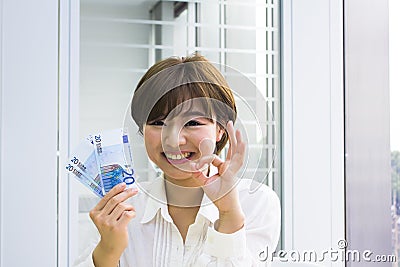Young woman holding Euros Stock Photo