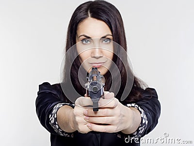 Young woman holding a gun Stock Photo