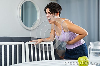 Young woman holding hands on the illness stomache Stock Photo