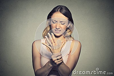 Young woman holding her painful wrist. Sprain pain Stock Photo