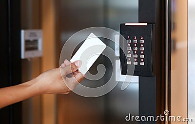 Young woman holding a key card to lock and unlock door. Stock Photo