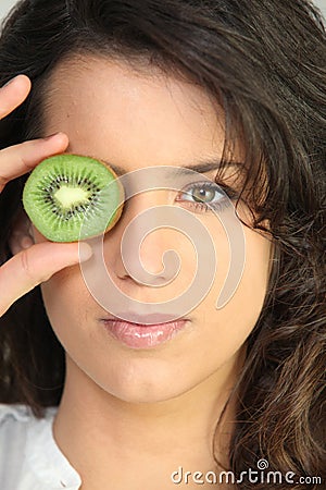 Young woman holding a kiwi Stock Photo