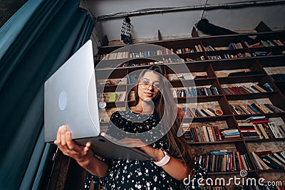 Young woman holding a laptop opening in her hands. Stock Photo