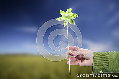 Young woman holding pinwheel windmill outdoors Stock Photo