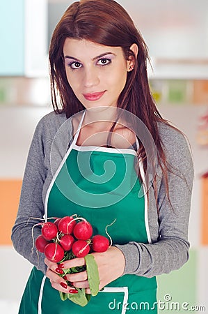 Young woman holding radishes Stock Photo