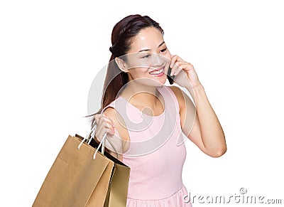 Young woman holding with shopping bag and talk to cellphone Stock Photo