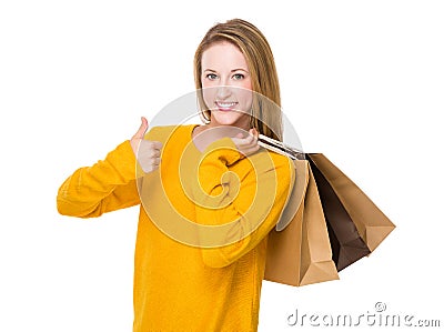 Young woman holding a shopping bag and thumb up Stock Photo