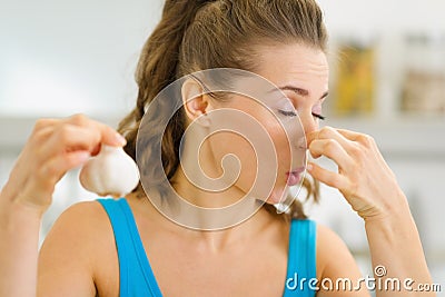 Young woman holding smelly garlic Stock Photo