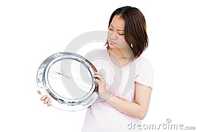 Young woman holding stainless steel clock Stock Photo