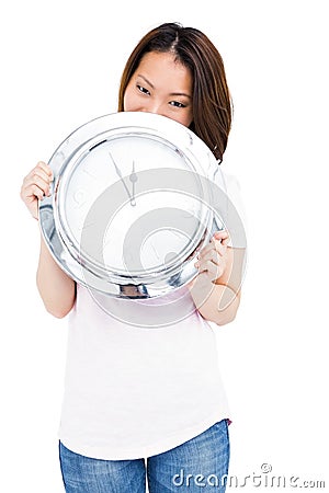 Young woman holding stainless steel clock Stock Photo