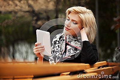 Young fashion woman using a tablet computer outdoor Stock Photo