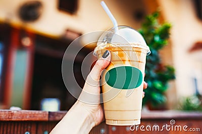 Young woman holding take away coffee cup. Stock Photo