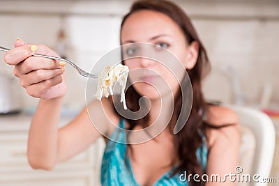 Young Woman Holding Up Forkful of Spaghetti Pasta Stock Photo