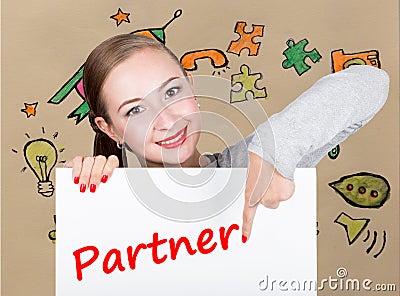 Young woman holding whiteboard with writing word: partner. Technology, internet, business and marketing. Stock Photo