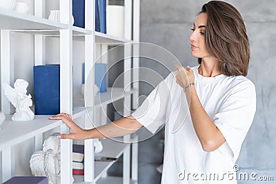 A young woman at home in a cozy white hoodie Stock Photo