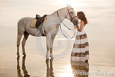 Young woman on a horse. Horseback rider, woman riding horse on b Stock Photo