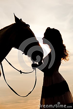 Young woman on a horse. Horseback rider, woman riding horse on b Stock Photo