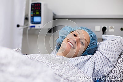 Young woman in hospital recovery room after surgery Stock Photo