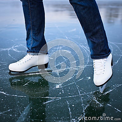 Young woman ice skating outdoors on a pond Stock Photo