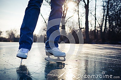 Young woman ice skating outdoors on a pond Stock Photo
