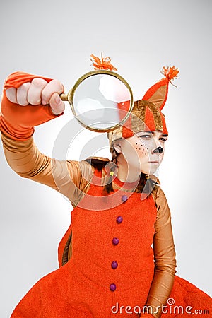 Young woman in image of squirrel with magnifying glass Stock Photo