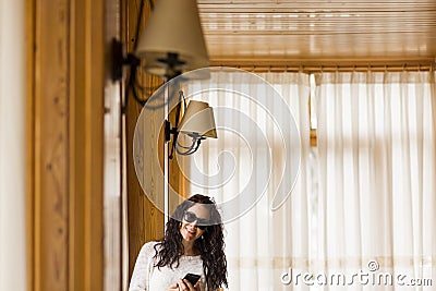 Young woman indoors portrait usinf smart phone Stock Photo