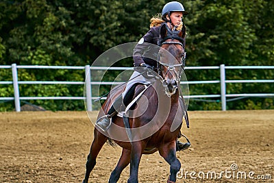 Young woman jockey in white black dress, takes part in equestrian competitions. Stock Photo