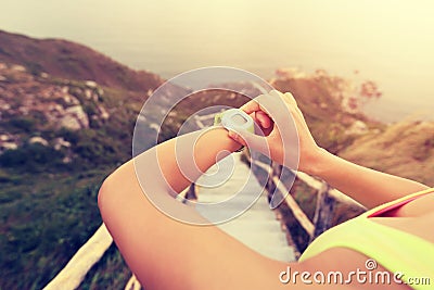 Young woman jogger ready to run set and looking at sports smart watch Stock Photo